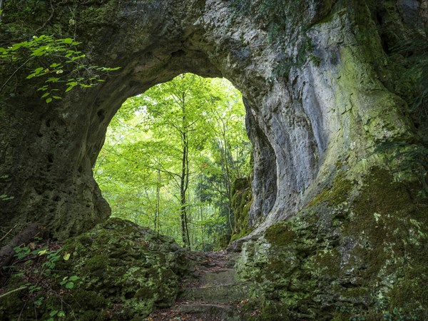Hiking trail leads through a rock gate, Goessweinstein, Franconian Switzerland, Upper Franconia, Franconia, Bavaria, Germany, Europe