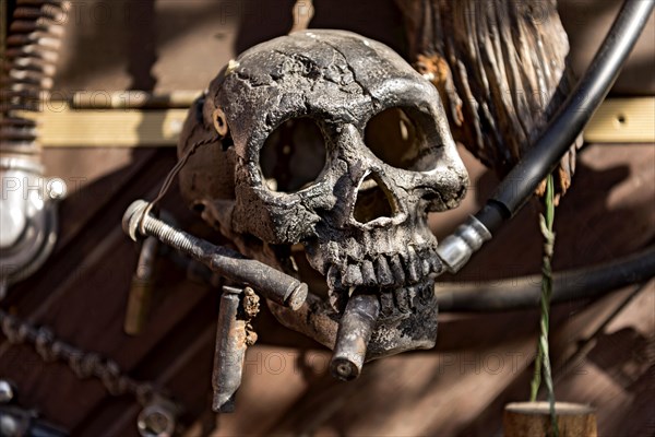 Old entrance door whimsically decorated, skull, engine parts, cartridge cases, tools, old town, Ortenberg, Vogelsberg, Wetterau, Hesse, Germany, Europe