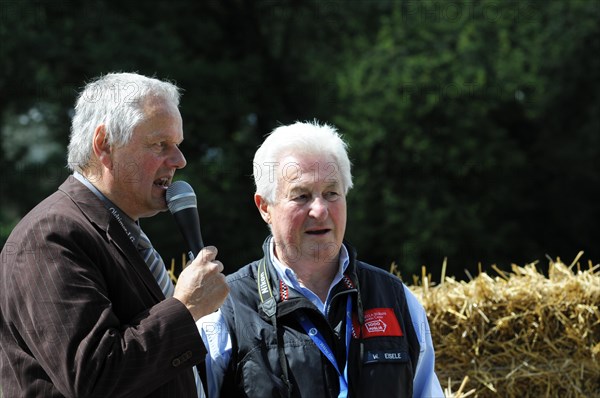 Two men conducting an interview at a car race, surrounded by spectators, SOLITUDE REVIVAL 2011, Stuttgart, Baden-Wuerttemberg, Germany, Europe