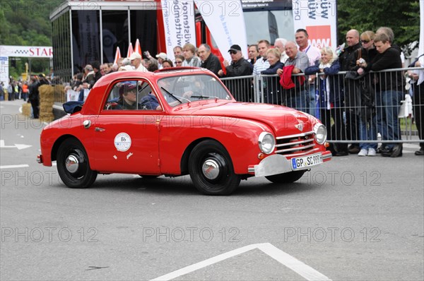 Red vintage car drives past a crowd at a racing event, SOLITUDE REVIVAL 2011, Stuttgart, Baden-Wuerttemberg, Germany, Europe