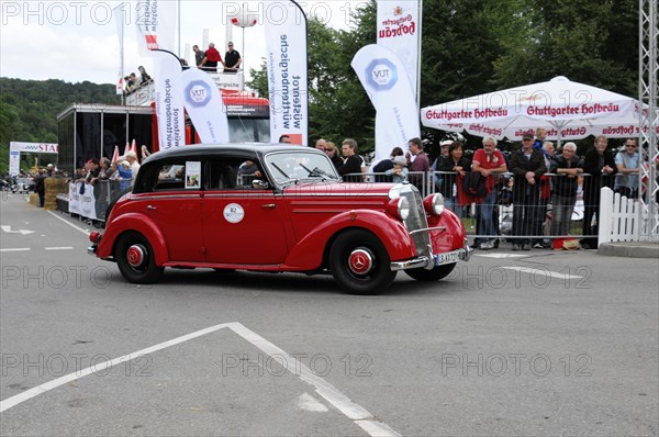 A red vintage car drives past a crowd at an event, SOLITUDE REVIVAL 2011, Stuttgart, Baden-Wuerttemberg, Germany, Europe