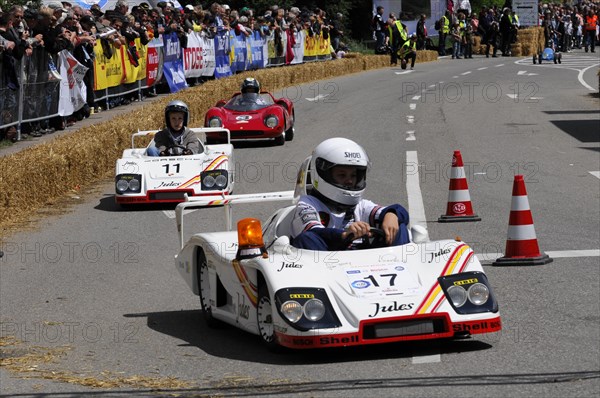 Racers concentrate on the race in white soapboxes in front of a crowd, SOLITUDE REVIVAL 2011, Stuttgart, Baden-Wuerttemberg, Germany, Europe
