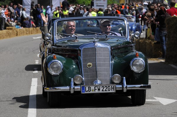 A dark green Mercedes classic car takes part in a parade in front of enthusiastic spectators, SOLITUDE REVIVAL 2011, Stuttgart, Baden-Wuerttemberg, Germany, Europe