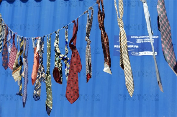 Art bazaar Marseille, Colourful ties hanging on a washing line in front of a blue background, Marseille, Departement Bouches-du-Rhone, Region Provence-Alpes-Cote d'Azur, France, Europe