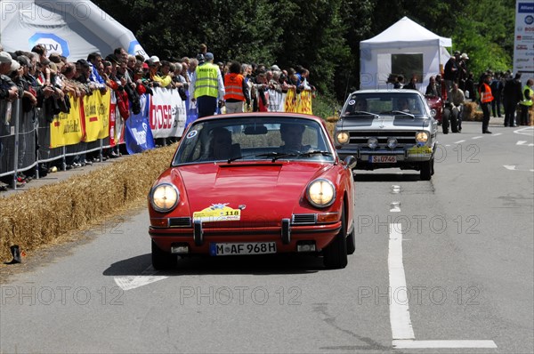 A Porsche 911 drives past a crowd at a car race, SOLITUDE REVIVAL 2011, Stuttgart, Baden-Wuerttemberg, Germany, Europe