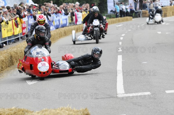 A red sidecar motorbike in a race, teamwork of rider and passenger, SOLITUDE REVIVAL 2011, Stuttgart, Baden-Wuerttemberg, Germany, Europe