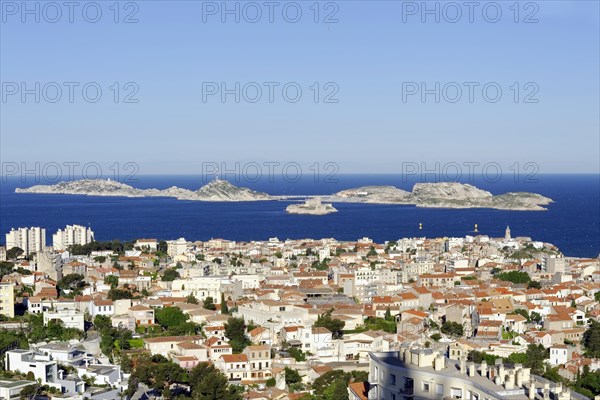 View of a coastal town with blue sea and islands in the background under a clear sky, Marseille, Departement Bouches-du-Rhone, Region Provence-Alpes-Cote d'Azur, France, Europe