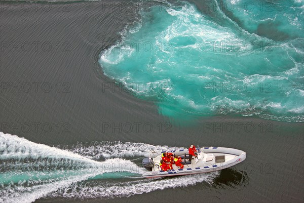 Powerboat with passengers between tidal eddies in the sea, Saltstraumen, Bodoe, Nordland, Norway, Europe