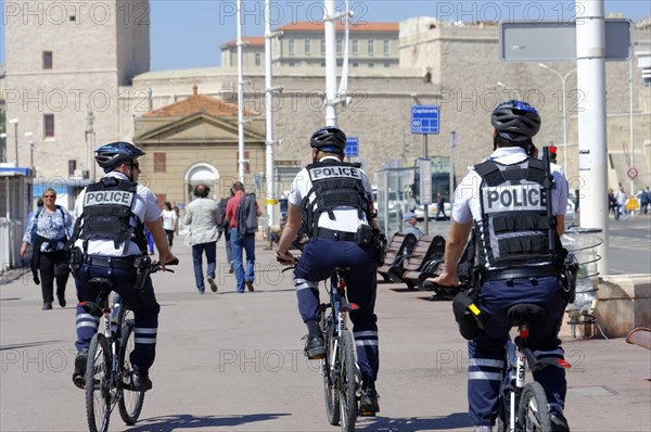 Police officers on bicycles patrolling a city street, Marseille, Bouches-du-Rhone department, Provence-Alpes-Cote d'Azur region, France, Europe