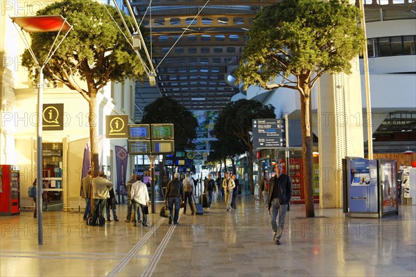 Marseille-Saint-Charles railway station, Marseille, travellers in an illuminated station concourse with trees and shops, Marseille, Departement Bouches-du-Rhone, Region Provence-Alpes-Cote d'Azur, France, Europe