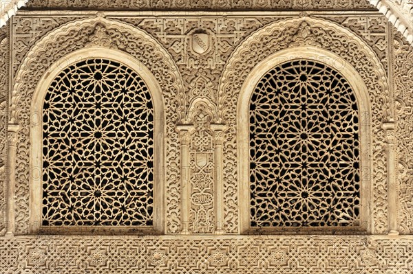 Artistic stone carvings, Alhambra, Granada, Two windows with ornate Islamic carvings in a stone wall, Granada, Andalusia, Spain, Europe