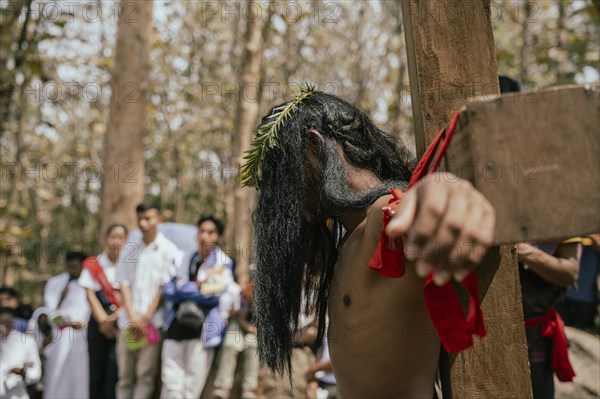 Christian devotees takes part in a perform to re-enactment of the crucifixion of Jesus Christ during a procession on Good Friday, on March 29, 2024 in Guwahati, Assam, India. Good Friday is a Christian holiday commemorating the crucifixion of Jesus Christ and his death at Calvary