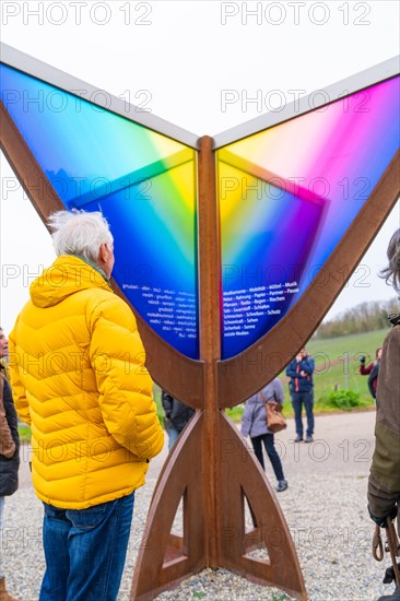 Visitors view an interactive artwork showing a spectrum of colours in nature, Jesus Grace Chruch, Weitblickweg, Easter hike, Hohenhaslach, Germany, Europe