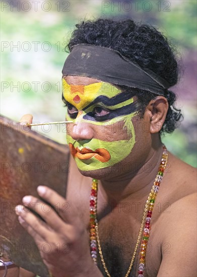 Kathakali performer or mime, 38 years old, makes up his face, Kochi Kathakali Centre, Kochi, Kerala, India, Asia