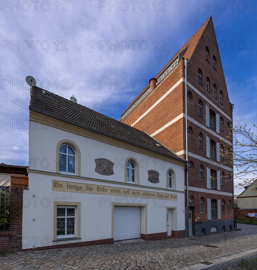 House with inscription: As long as the earth stands, sowing and harvesting shall not cease, old grain silo, Havelberg, Saxony-Anhalt, Germany, Europe
