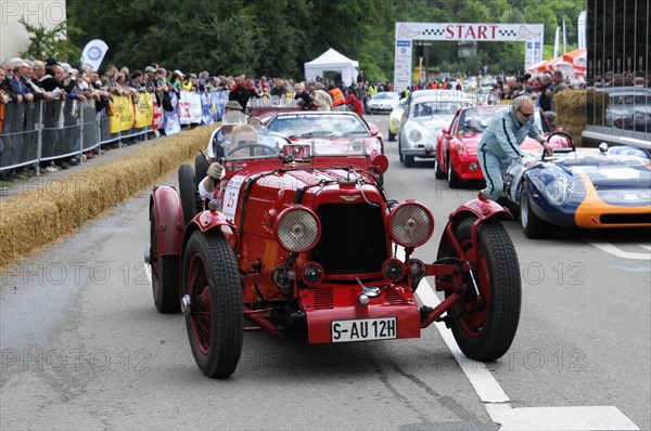 A red vintage racing car at an event surrounded by spectators, SOLITUDE REVIVAL 2011, Stuttgart, Baden-Wuerttemberg, Germany, Europe