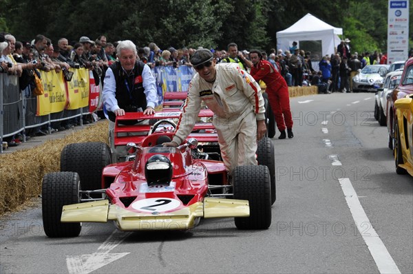 A red formula racing car is pushed by helpers on a race track, SOLITUDE REVIVAL 2011, Stuttgart, Baden-Wuerttemberg, Germany, Europe