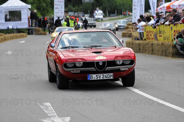 A red Alfa Romeo sports car on the road at a classic car rally, SOLITUDE REVIVAL 2011, Stuttgart, Baden-Wuerttemberg, Germany, Europe