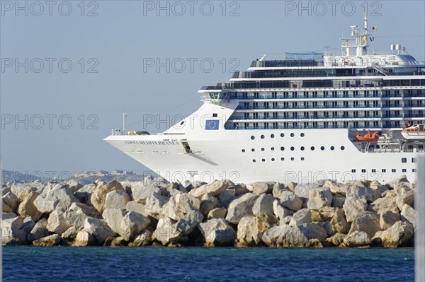 MSC cruise ship in front of a coastline with wave-washed rocks, Marseille, Bouches-du-Rhone department, Provence-Alpes-Cote d'Azur region, France, Europe