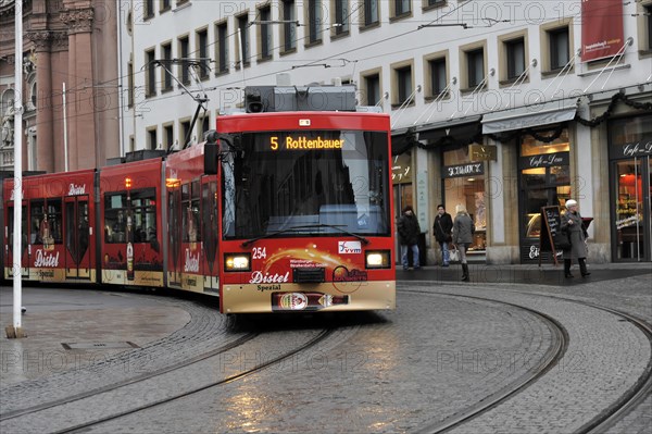 Wuerzburg, Red tram moves through the city centre of Wuerzburg along the tracks, Wuerzburg, Lower Franconia, Bavaria, Germany, Europe