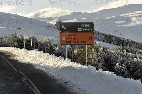 Mountains in Andalusia, Mountain range with snow, near Pico del Veleta, 3392m, Gueejar-Sierra, Sierra Nevada National Park, A winter road with a traffic sign, surrounded by snowy landscape, Costa del Sol, Andalusia, Spain, Europe