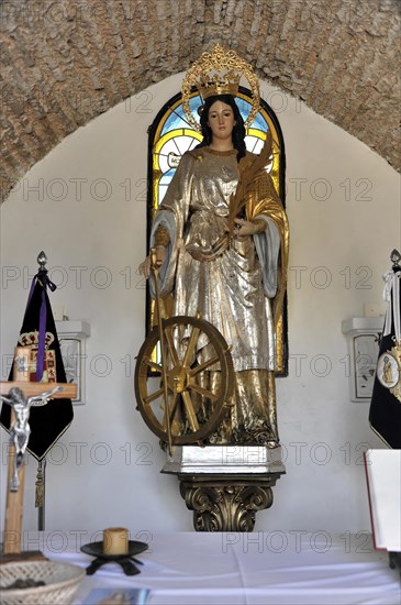 Castillo de Santa Catalina in Jaen, A golden statue of a saint with a wheel in a church, Granada, Andalusia, Spain, Europe