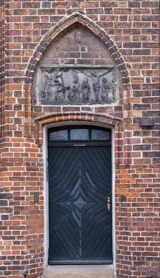 Relief with crucified Christ above a door of the parish church of St Laurentius, Havelberg, Saxony-Anhalt, Germany, Europe