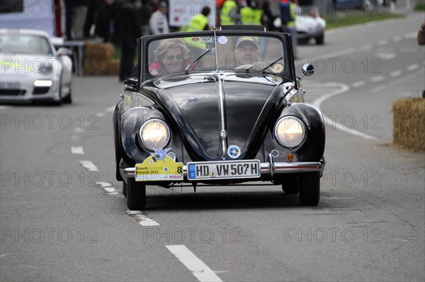 An old Volkswagen Beetle convertible drives past spectators at a car race, SOLITUDE REVIVAL 2011, Stuttgart, Baden-Wuerttemberg, Germany, Europe