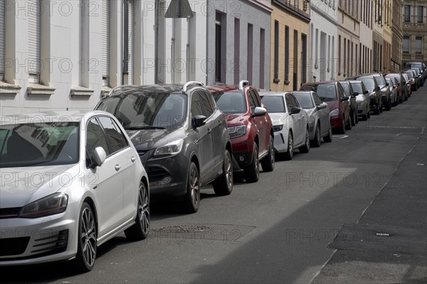 Lined up parked cars in a residential street, Vohwinkel, Wuppertal, Bergisches Land, North Rhine-Westphalia, Germany, Europe