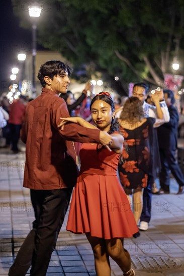 Oaxaca, Mexico, The weekly Wednesday dance in the zocalo, or central square. This night the dance was on Valentine's Day, with many dancers wearing red, Central America
