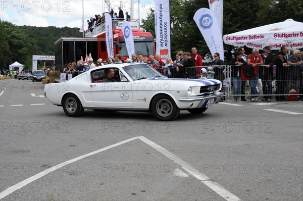 A white Ford Mustang drives past spectators at a classic car race, SOLITUDE REVIVAL 2011, Stuttgart, Baden-Wuerttemberg, Germany, Europe