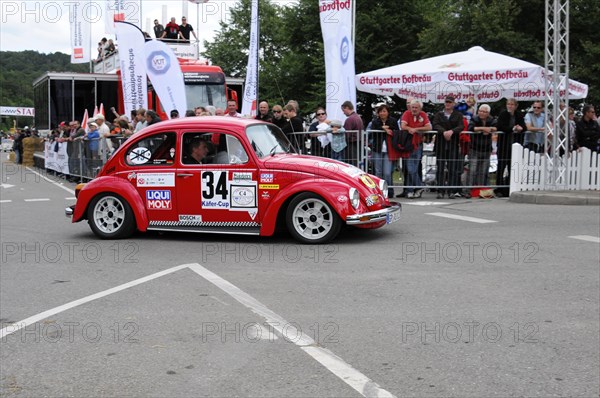 A red Volkswagen Beetle classic car with racing number surrounded by spectators, SOLITUDE REVIVAL 2011, Stuttgart, Baden-Wuerttemberg, Germany, Europe