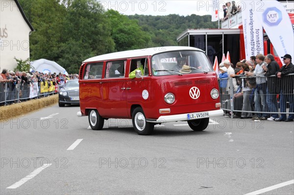 Red VW bus driving on a road with spectators in the background, SOLITUDE REVIVAL 2011, Stuttgart, Baden-Wuerttemberg, Germany, Europe