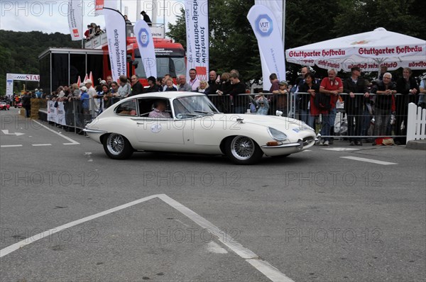 A white Jaguar E-Type classic car surrounded by spectators at a racing event, SOLITUDE REVIVAL 2011, Stuttgart, Baden-Wuerttemberg, Germany, Europe