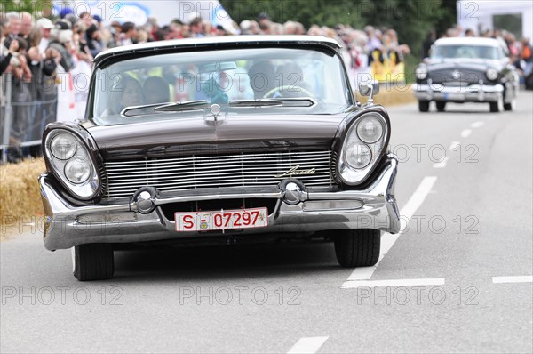 A black Plymouth vintage car drives alongside other cars in a race, SOLITUDE REVIVAL 2011, Stuttgart, Baden-Wuerttemberg, Germany, Europe