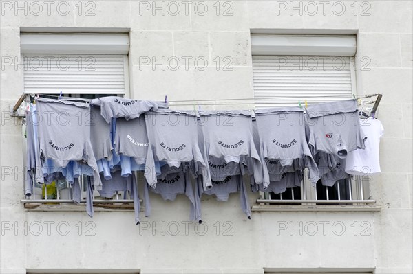 Marseille, row of clothes hanging on a washing line in front of a window, Marseille, Departement Bouches-du-Rhone, Provence-Alpes-Cote d'Azur region, France, Europe