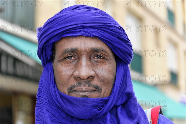 Businessman from Morocco, close-up of a contemplative man in a blue turban, Marseille, Departement Bouches-du-Rhone, Region Provence-Alpes-Cote d'Azur, France, Europe