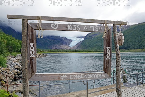 View of glacier tongue and lake through a wooden window, Svartisen, Kystriksveien, FV 17, Norway, Europe