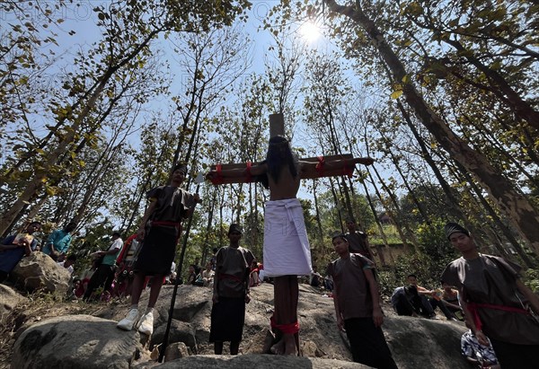 Christian devotees takes part in a perform to re-enactment of the crucifixion of Jesus Christ during a procession on Good Friday, on March 29, 2024 in Guwahati, Assam, India. Good Friday is a Christian holiday commemorating the crucifixion of Jesus Christ and his death at Calvary