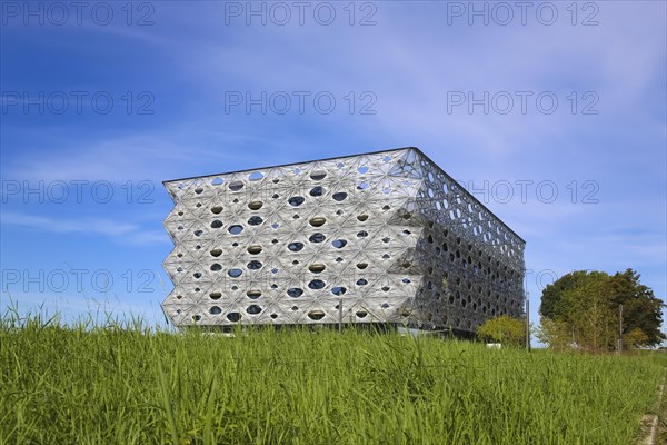 Reutlingen University, Reutlingen University, Texoversum, German University Building Award 2024 for TEXOVERSUM, modern architecture, facade made of carbon and glass fibres, mesh, innovative, identity-creating, unique facade, campus, place of learning, special, extraordinary new building for textile courses, light, airy, airy, holes, architectural eye-catcher, green meadow, university campus, Reutlingen, Baden-Wuerttemberg, Germany, Europe