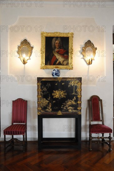 Langenburg Castle, Classic interior with portrait painting and candlesticks on the wall and two red chairs, Langenburg Castle, Langenburg, Baden-Wuerttemberg, Germany, Europe