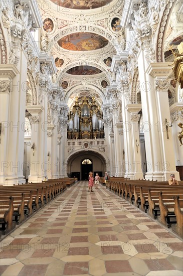 St Stephan Cathedral, Passau, Long view through the nave with organ in the background and visitors nearby, Passau, Bavaria, Germany, Europe