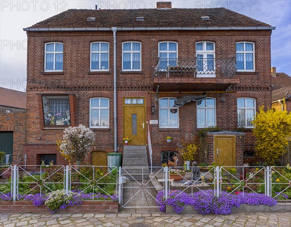 Brick house with flower-decorated front garden, Havelberg, Saxony-Anhalt, Germany, Europe