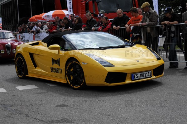 A yellow Lamborghini sports car presents itself to spectators during a car race, SOLITUDE REVIVAL 2011, Stuttgart, Baden-Wuerttemberg, Germany, Europe