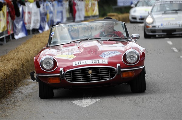 A red Jaguar E-Type convertible drives on a closed-off race track, SOLITUDE REVIVAL 2011, Stuttgart, Baden-Wuerttemberg, Germany, Europe