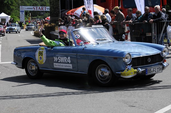 A blue open-top vintage rally car with a smiling driver in front of spectators, SOLITUDE REVIVAL 2011, Stuttgart, Baden-Wuerttemberg, Germany, Europe