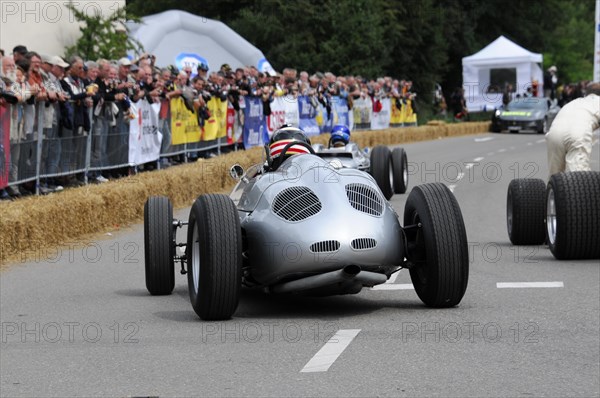 A classic racing car drives past an enthusiastic crowd at a race track, SOLITUDE REVIVAL 2011, Stuttgart, Baden-Wuerttemberg, Germany, Europe