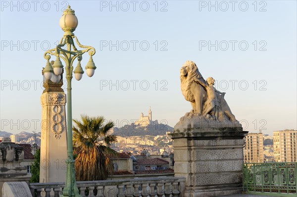 View of a city with lantern and statue in the foreground, Marseille, Departement Bouches-du-Rhone, Region Provence-Alpes-Cote d'Azur, France, Europe