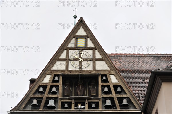 Wuerzburg, Gable of a building with clock and small carillon under a cloudy sky, Wuerzburg, Lower Franconia, Bavaria, Germany, Europe