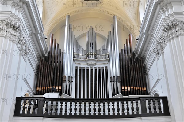 The organ in the Neumuenster collegiate monastery, Wuerzburg, close-up of an organ with many pipes and ornamental wooden railings on a balcony, Wuerzburg, Lower Franconia, Bavaria, Germany, Europe